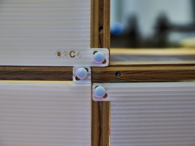 Color up of the plastic panel connectors on the signature Kinetic shelves.