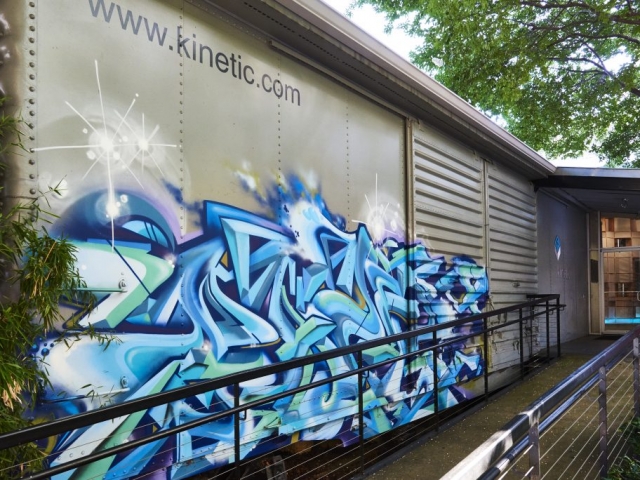 Photo of the boxcar placed along the front entrance ramp complete with artwork and web address.