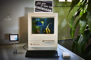 A photo of a fish tank inside a Macintosh Classic.