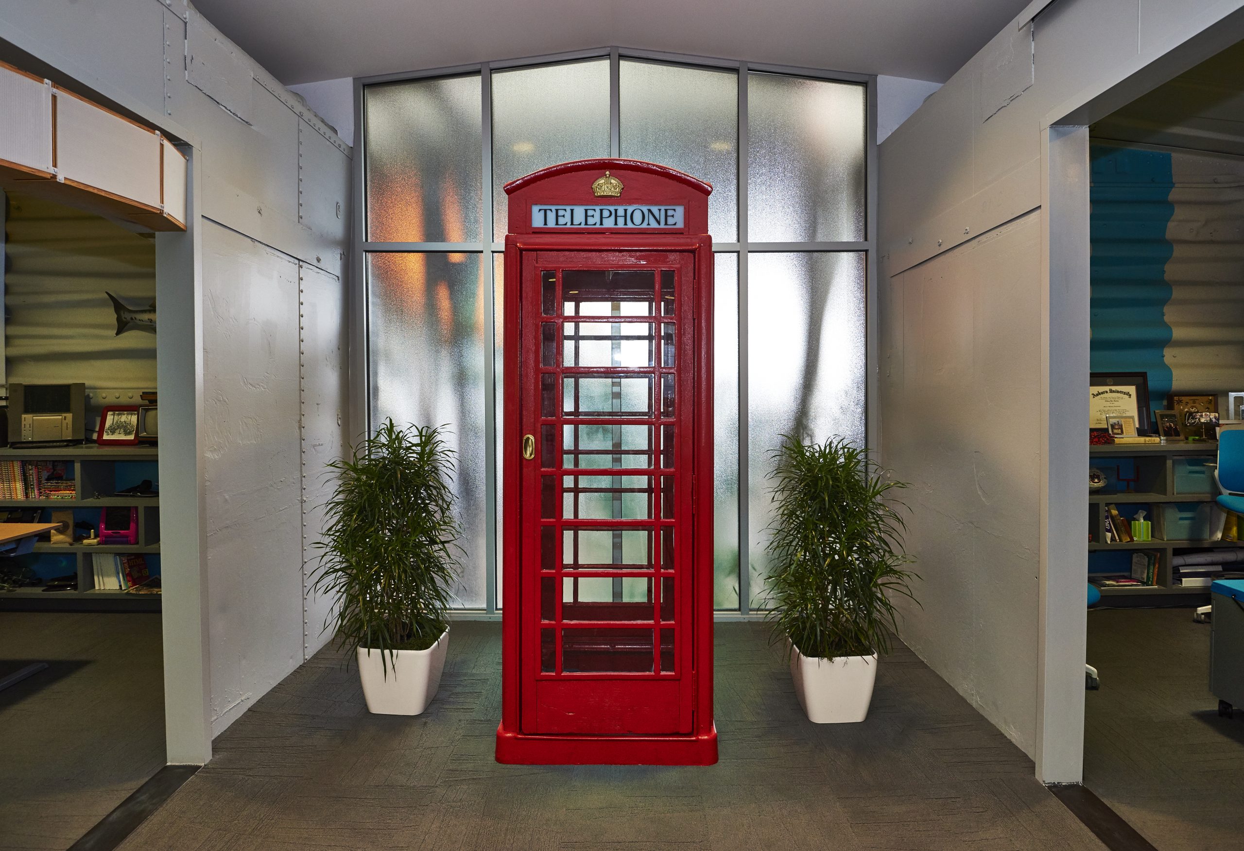 Photo of old red telephone booth.