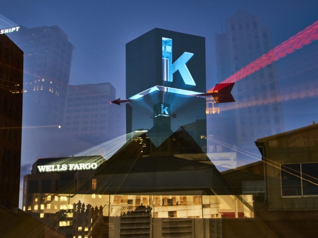 Photo of Kinetic's logo at night with a blue light inside illuminating it.